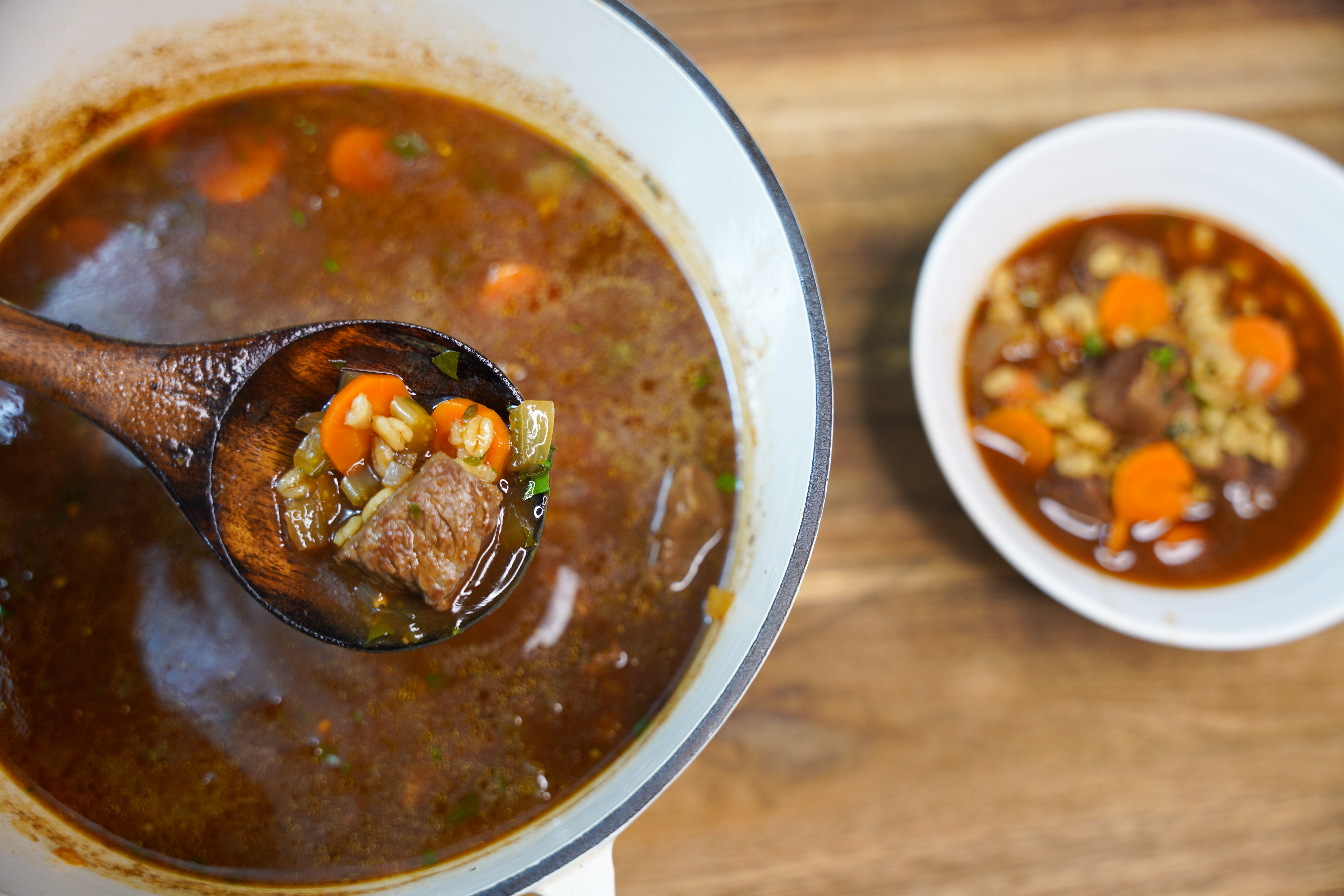 bowl of soup with a wooden spoon